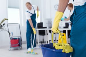 Image,of,person,holding,mop,pail,and,man,cleaning,floor