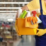 Male,janitor,with,cleaning,supplies,in,shopping,mall,,closeup.,space